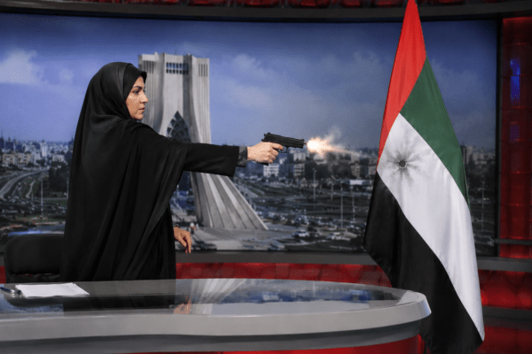 International Outrage! Iranian TV Anchor Fires AK-47 Rifle at UAE Flag on Live Broadcast!
