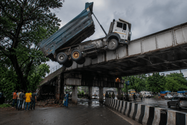 Speeding Dumper Hits Iron Bridge in Vasai; Left Dangling Mid-Air After Hydraulic System Fails!
